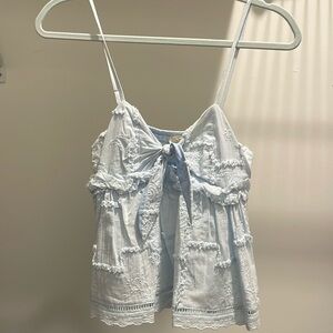 Adorable baby blue tank! The bow is adjustable! Fits more like a small!